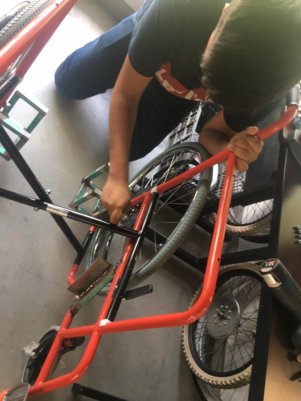 Daniel Longoria y Alexis Avilés trabajando en la silla de ruedas